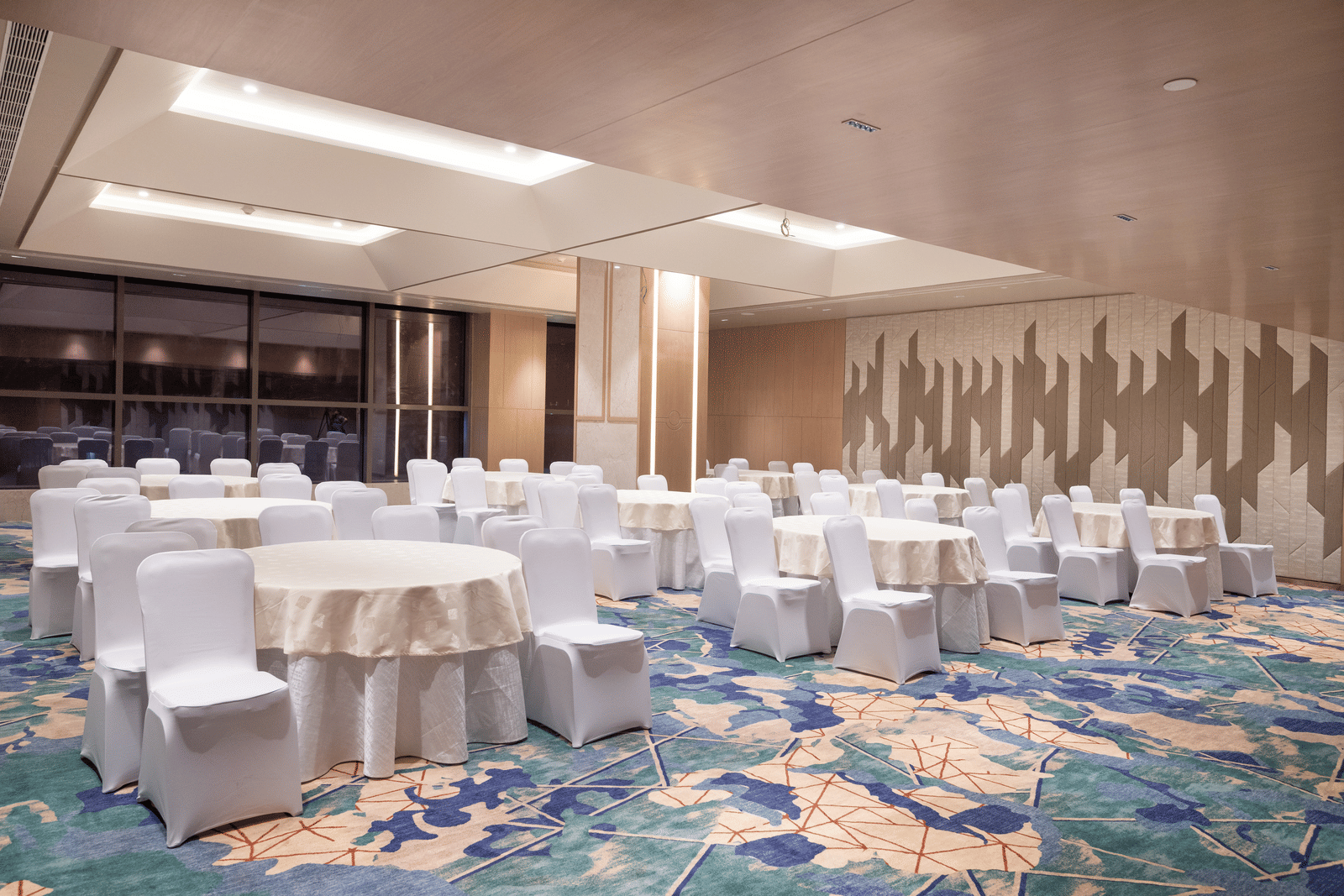 Spacious room with banquet-style seating and warm lighting at Merlis Hotel, Coimbatore.