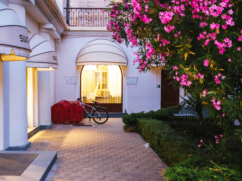 The exterior of a building featuring a pathway leading to the entrance of the building.