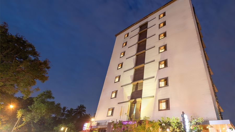 Facade view of Oriental Aster, Mumbai, against night sky.