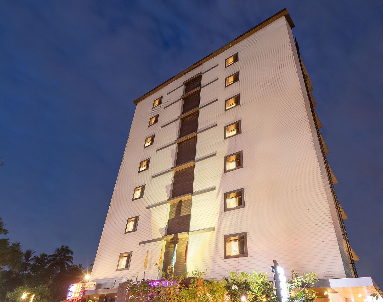 Facade view of Oriental Aster, Mumbai, against night sky.