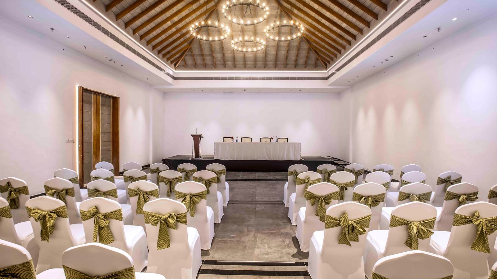 An image of the banquet hall in Wayanad with seating arrangement and a chandelier | Great Trails Wayanad by  GRT hotels.