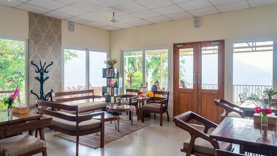 seating arrangements inside the restaurant with modern interiors at Neer Ganga Resorts
