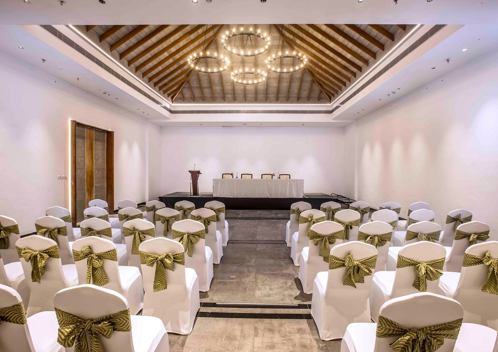 An image of the banquet hall in Wayanad with seating arrangement and a chandelier | Great Trails Wayanad by  GRT hotels.