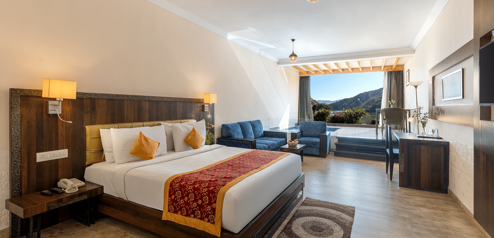 A wide angle shot of a bed with a runner on it and a lamp on the ceiling - Via Lakhela Resort & Spa, Kumbhalgarh