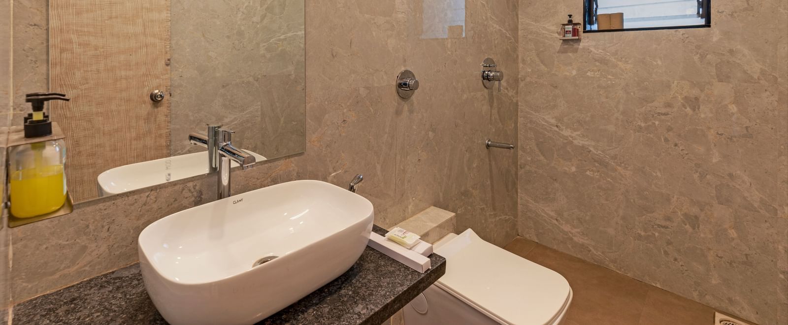 Modern bathroom at Emerald Retreat, Tungarli with stylish beige tiling, a rain shower, and contemporary fittings.