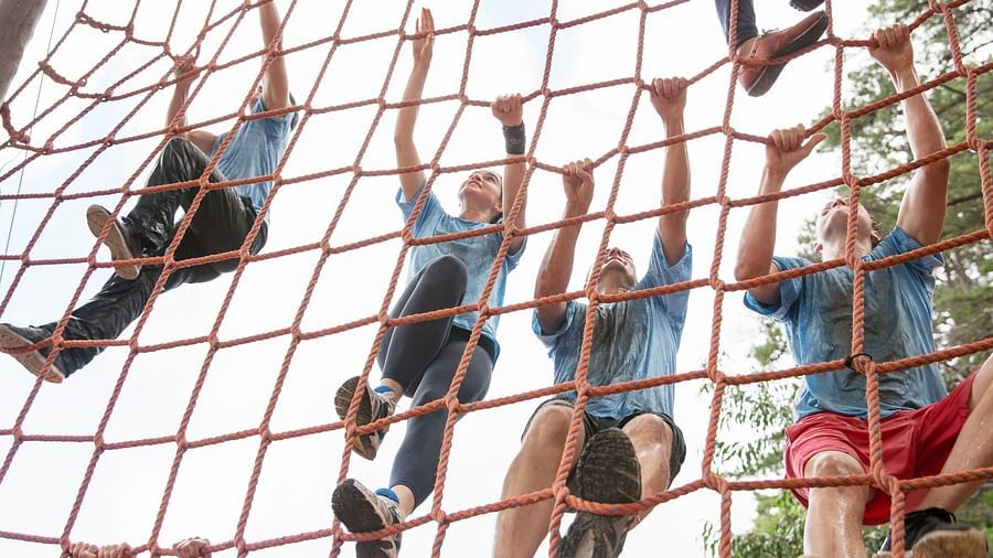 Team climbing net on boot camp course