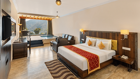 Hotel room with a bed annd a patterned runner on it with a scenic view - Via Lakhela Resort & Spa, Kumbhalgarh