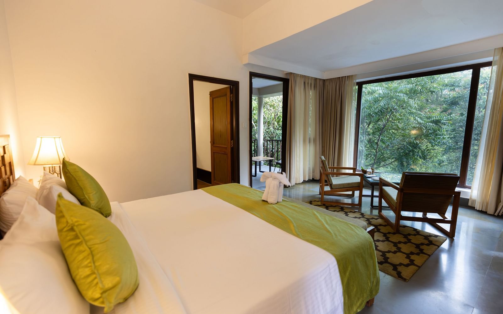 Premium Room at Saraca Resort & Spa Corbett with a double bed and a coffee table arrangement