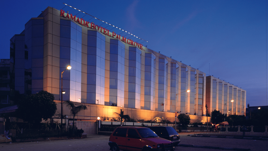 Facade view during twilight with the lights on and signage lit - Hotel Ramada Plaza Palm Groveduring twilight with the lights on and signage lit - Hotel Ramada Plaza Palm Grove