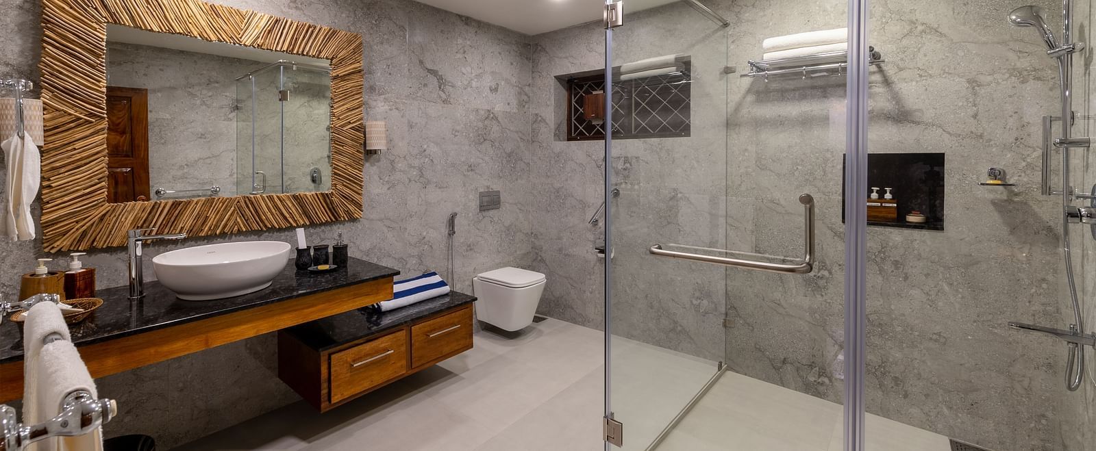 Modern bathroom with a large mirror, sink, and glass-enclosed shower - BluSalzz Collection - Tranquil Resort, Wayanad