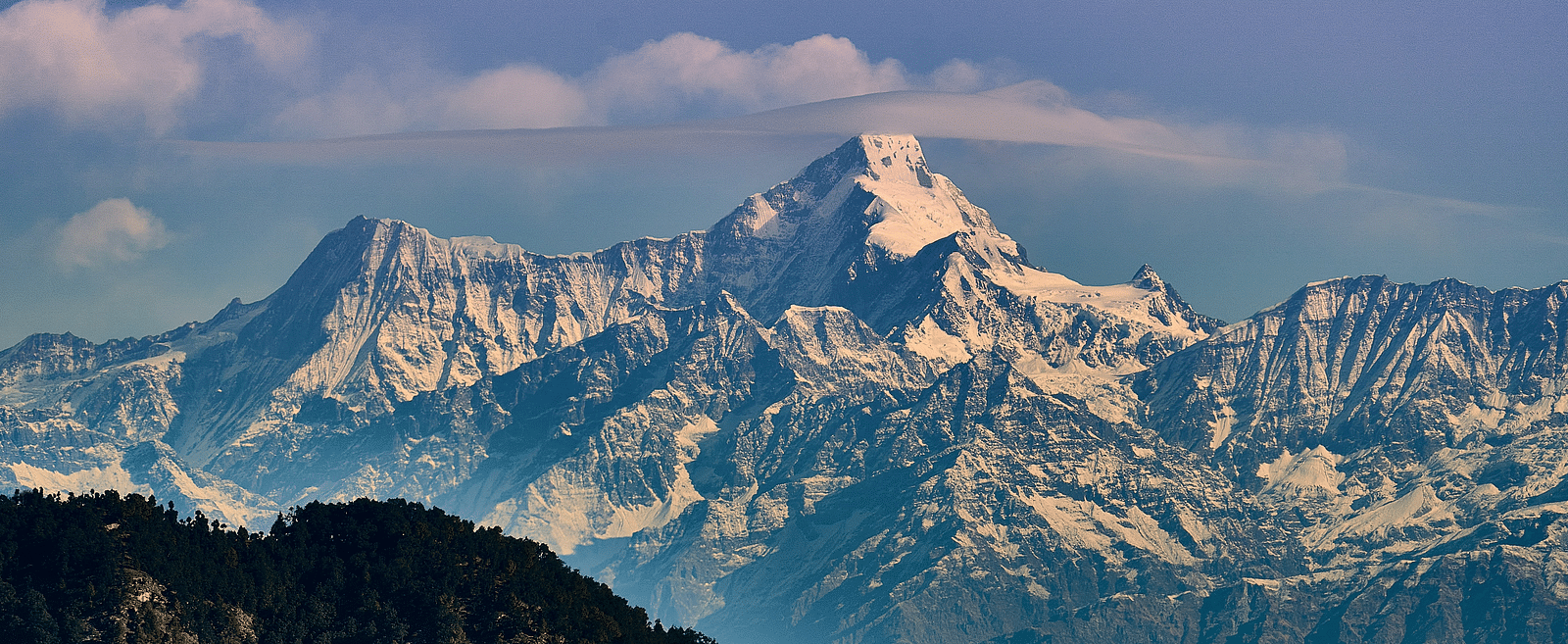 A panoramic view of the Himalayan range with pink hue filled sky