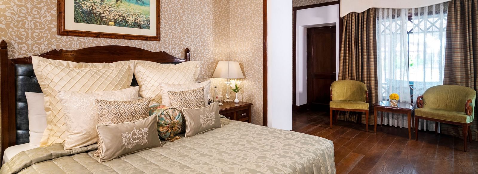 full view of the club room exposing the bed and the seating area at The Claridges Nabha Residence
