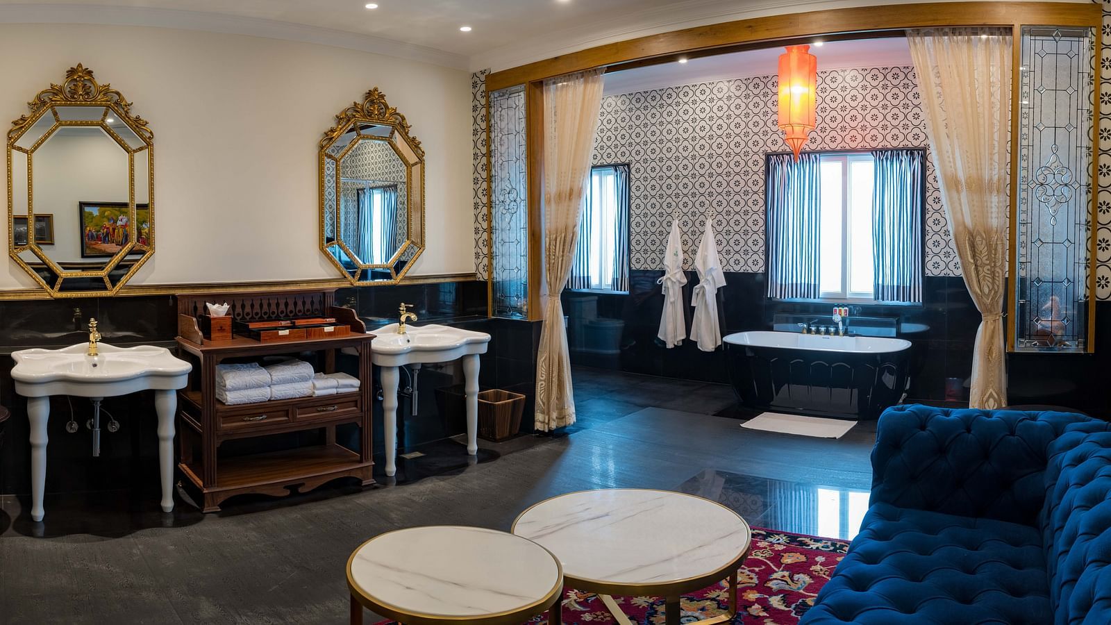 Elegant suite with vintage-style furniture and warm lighting at MAYFAIR Tea Resort, Siliguri