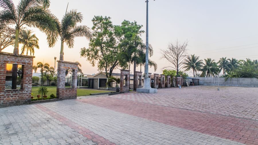 An outdoor area with paving and some greenery at The Citi Residenci Hotel, Asansol.