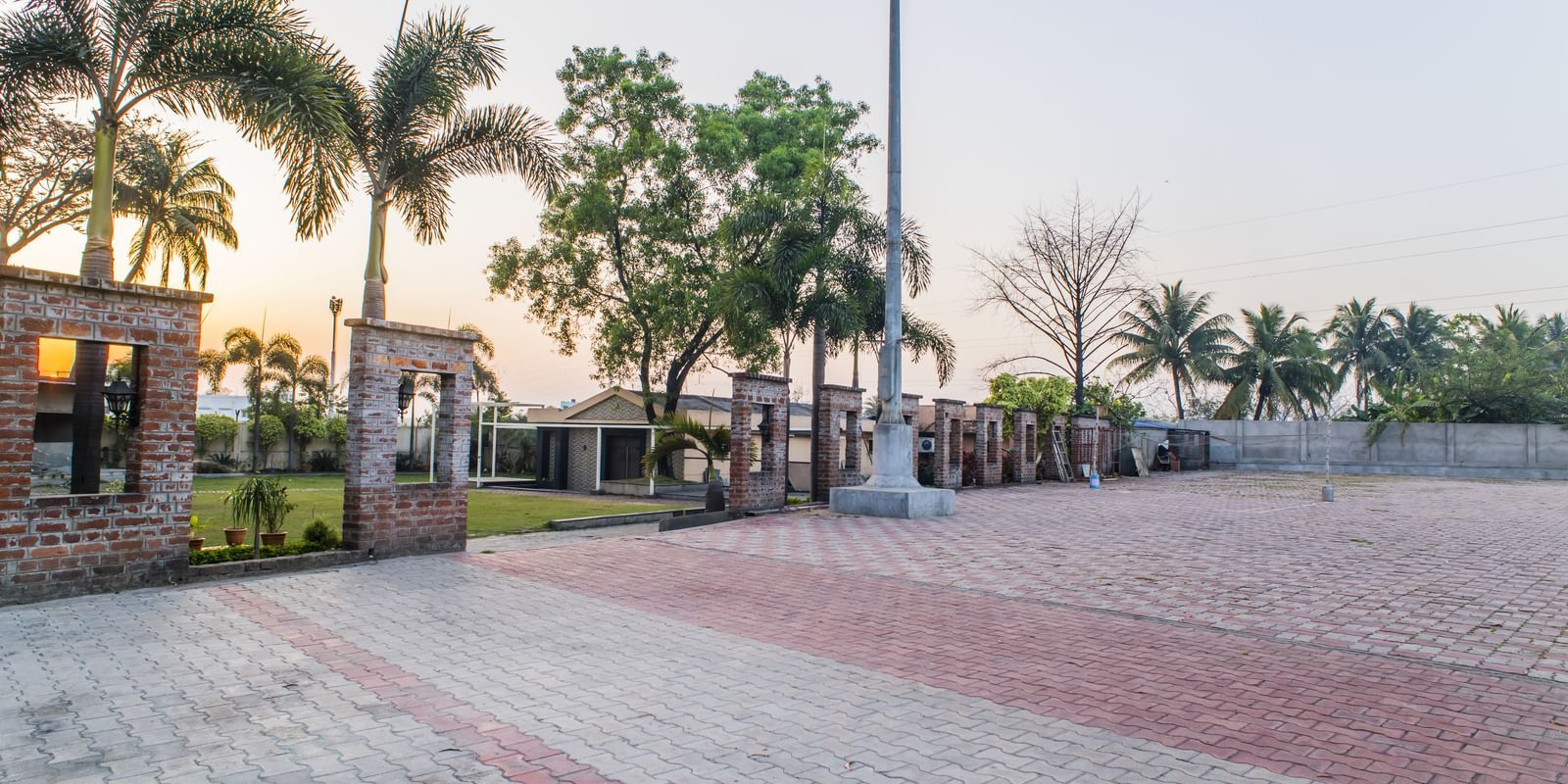 An outdoor area with paving and some greenery at The Citi Residenci Hotel, Asansol.