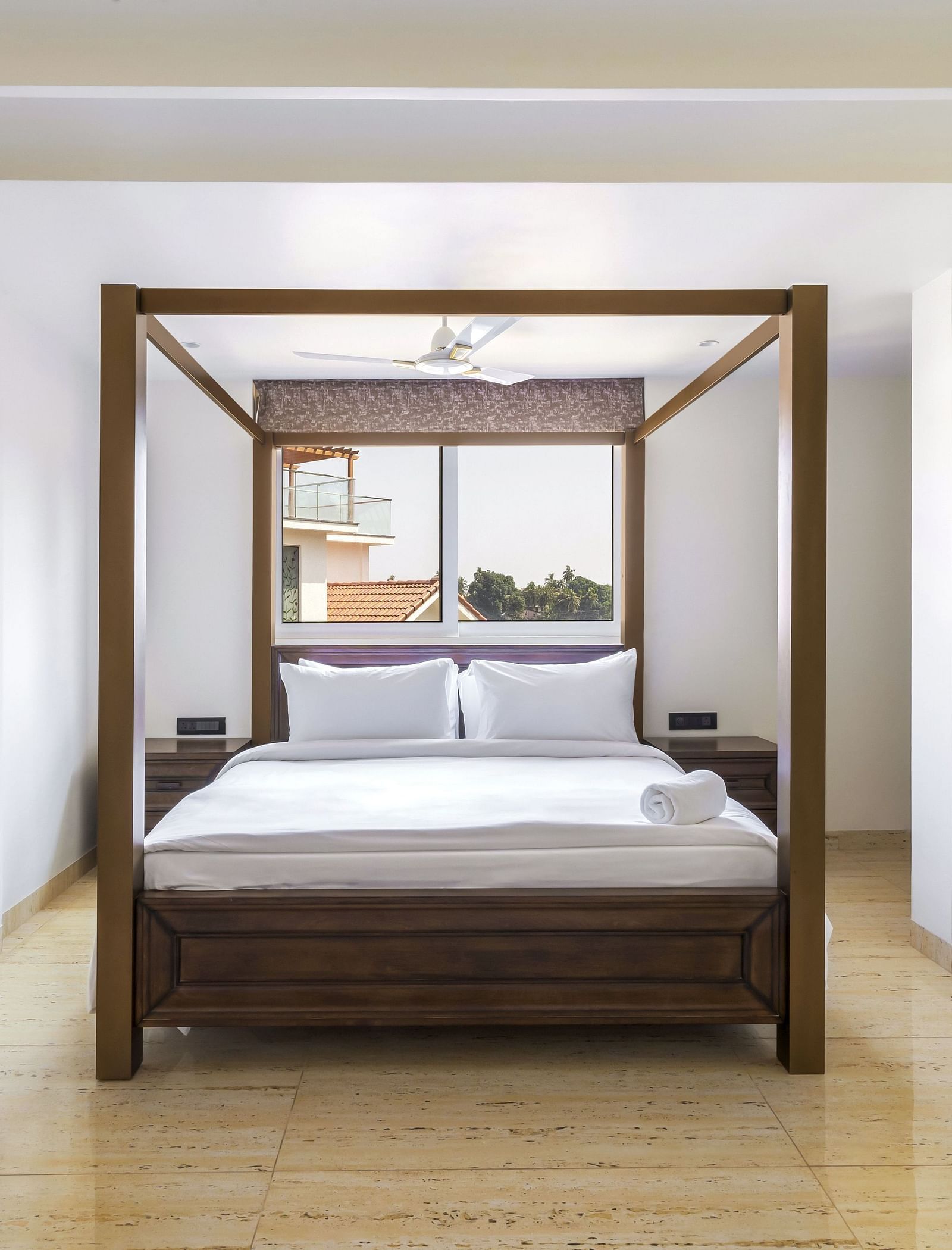 A double bed with wooden beams inside one of the rooms - The Tanisi Hotels & Resorts, Goa