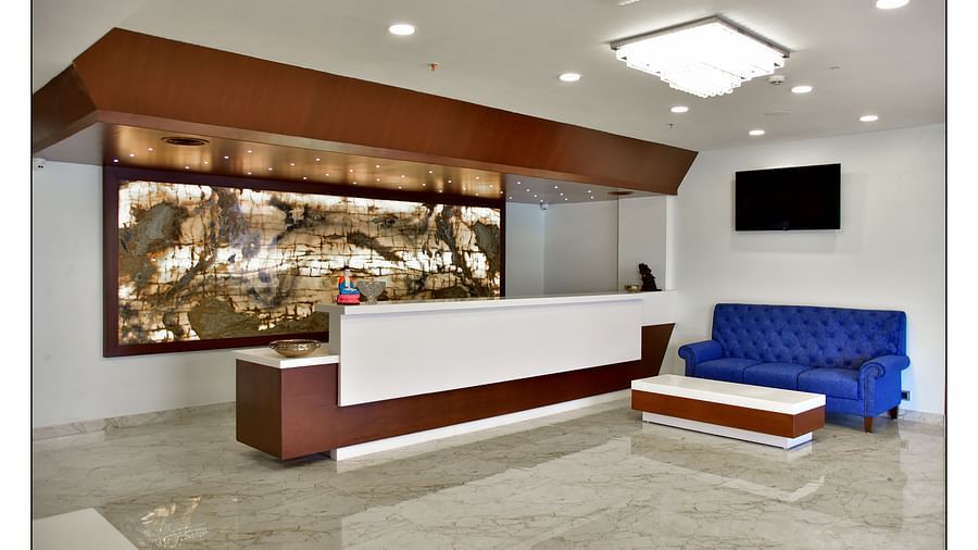 different angles of the reception area with blue coloured couch in a corner and well-lit surrounding - Royal Lotus View Resotel1