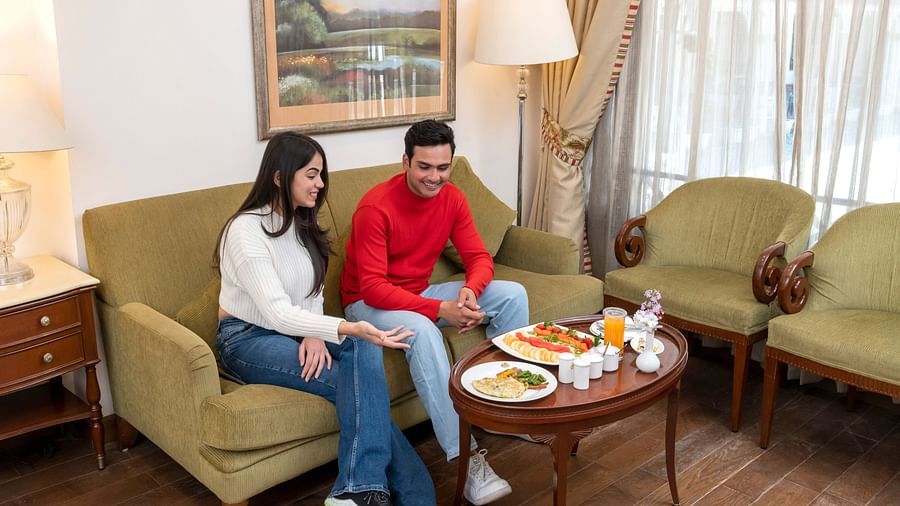 an image of a couple enjoying breakfast at the seating area in our suite in Mussoorie
