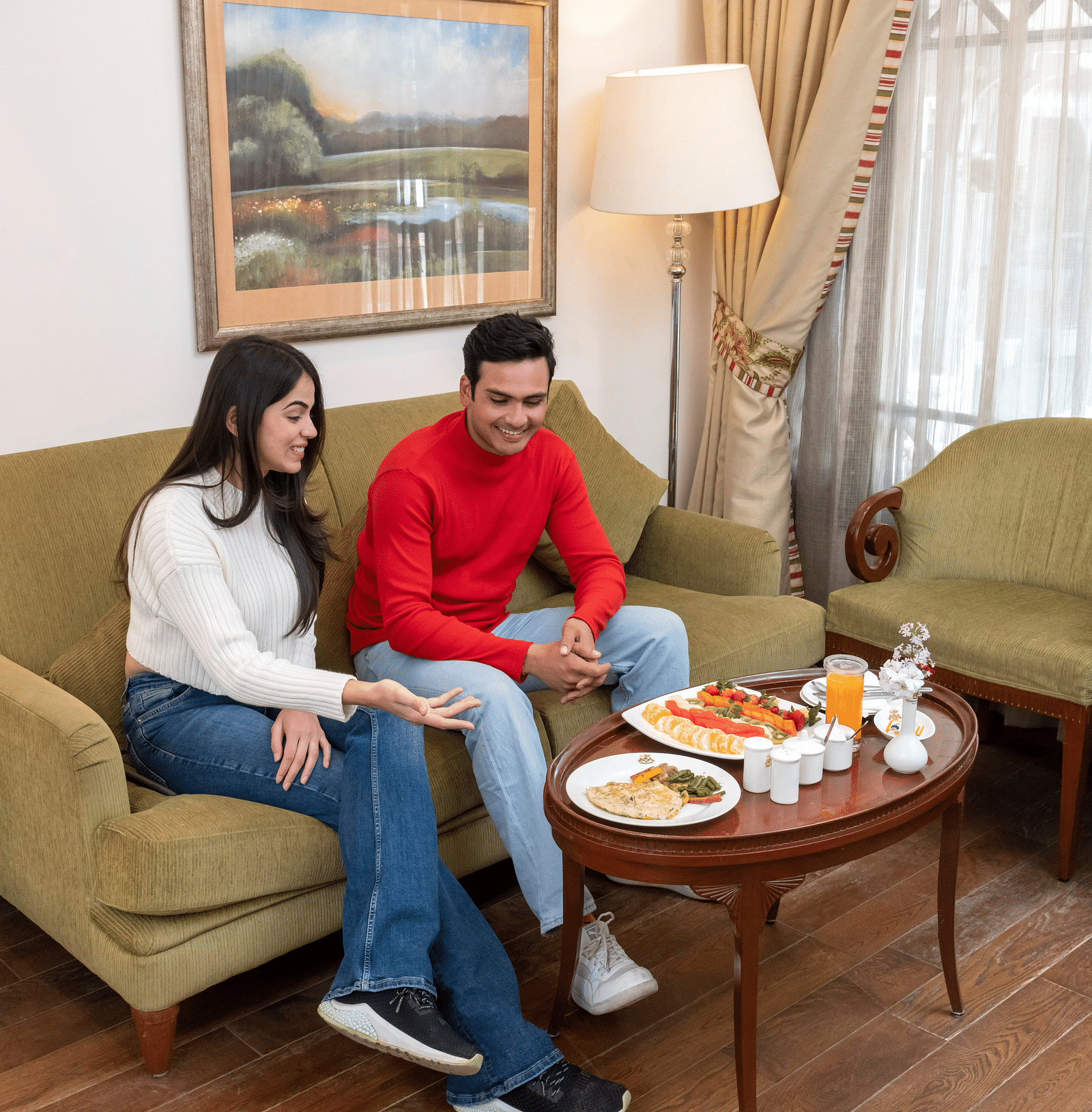 a couple having a huge spread of breakfast