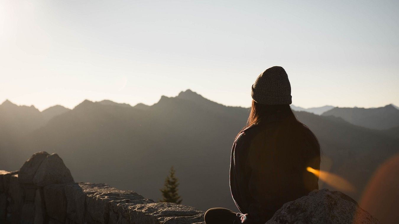 Image of a woman meditating in an open space