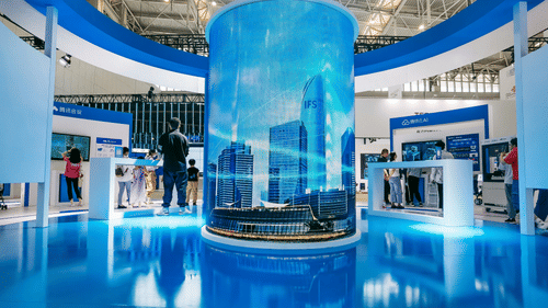 An overview of an exhibition centre and in the centre an art installing and stalls on either side of it.