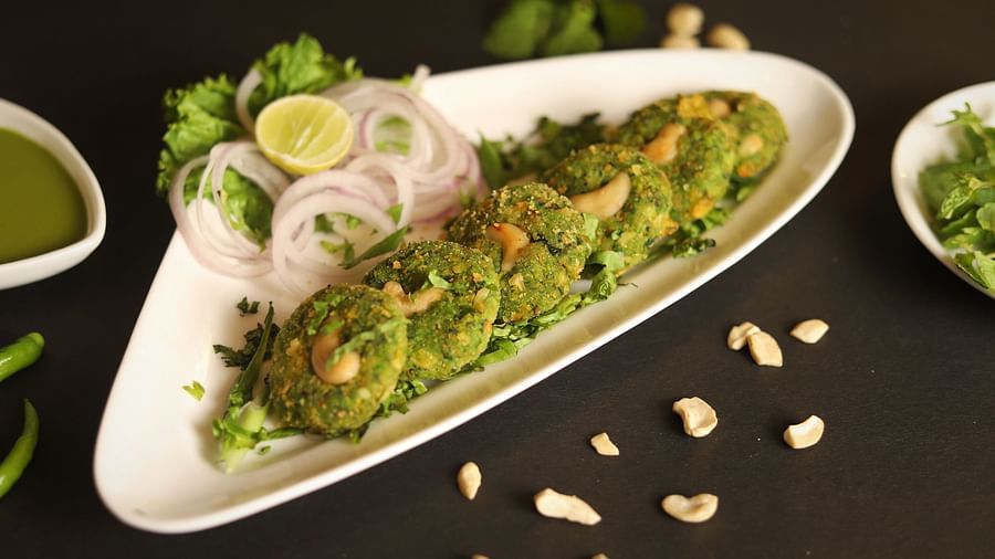 An image of a a savoury served in a pallter along with lemon and onions at a restaurant of Five Elements Hotels North Avenue, Delhi