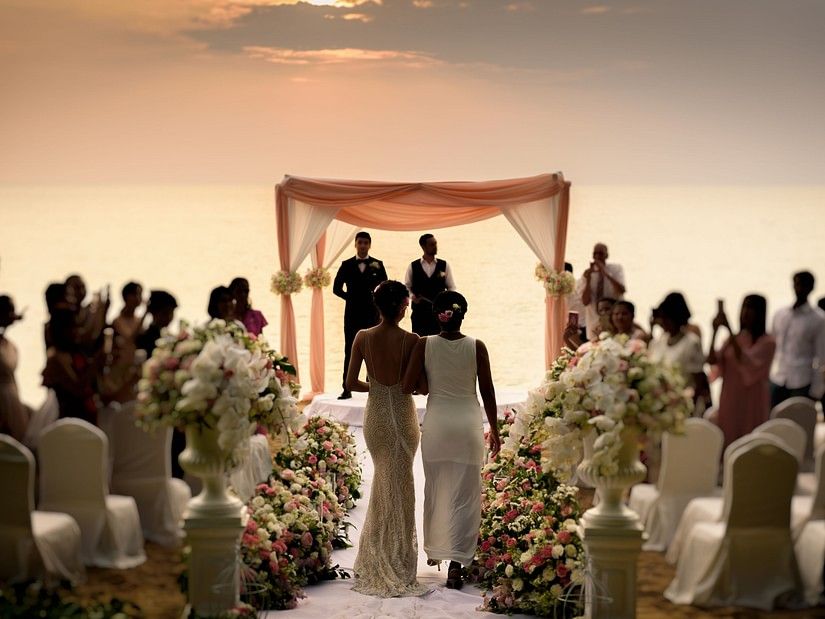 image of the bride accompanied by her mother walking down the aisle - Maikhao Dream Villa Resort & Spa, Phuket