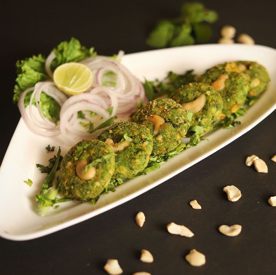 An image of a a savoury served in a pallter along with lemon and onions at a restaurant of Five Elements Hotels North Avenue, Delhi
