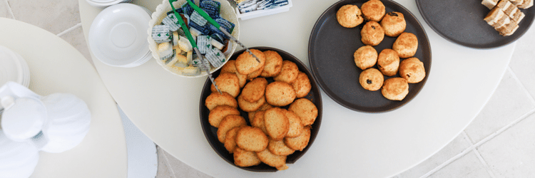 Neatly served food in the dining table at The Soco House, including three different items and cutlery on the side.
