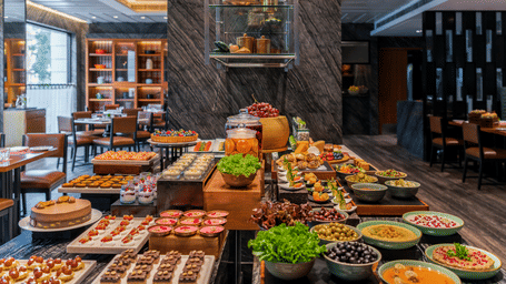 An extensive and beautifully presented gourmet food buffet spread inside a luxury dining venue - Raintree, St. Mary's Road