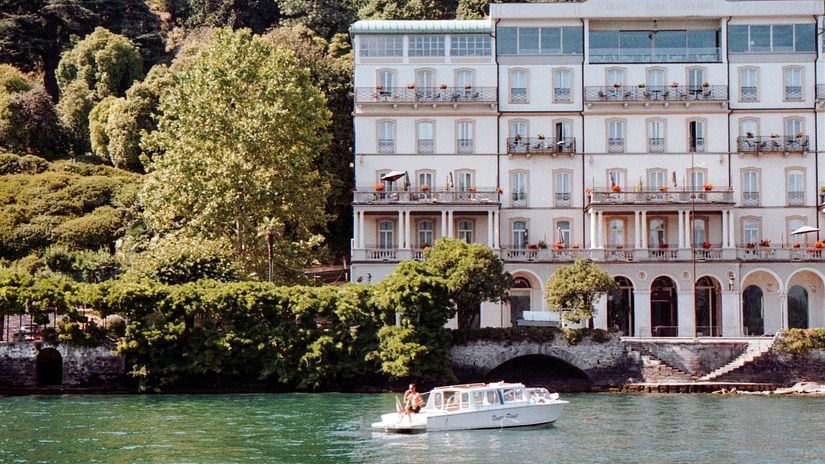 Boat on a lake with a building by the shore