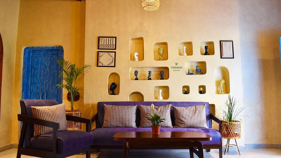 a warmly-lit interior of Classic Villas focusing a plush sofa at Themis Mudhouse - A Nature's Retreat Resort & Wellness
