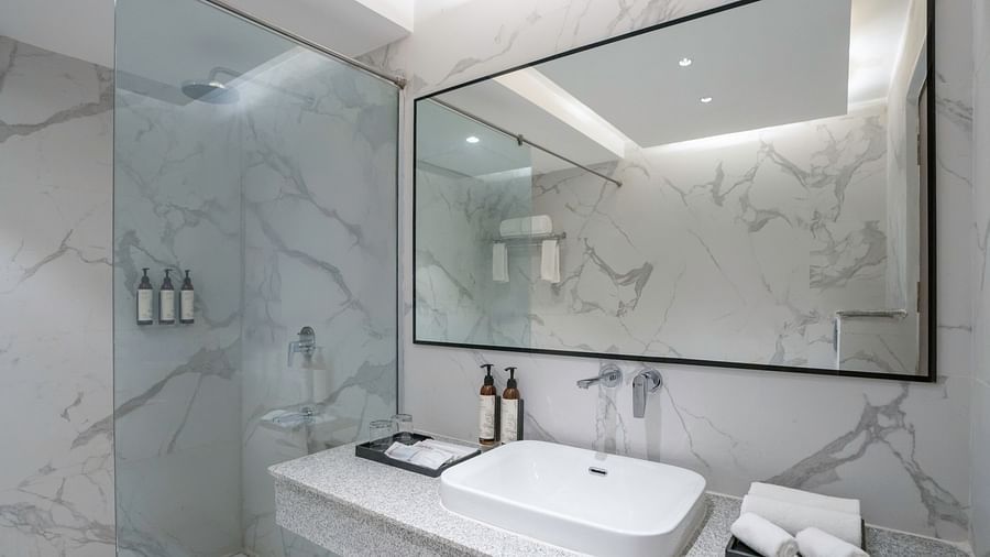 Stylish bathroom with a modern vanity and large mirror.