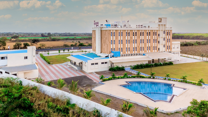 bird's eye view of The Orchid Hotel, Jamnagar with evening sky in the background