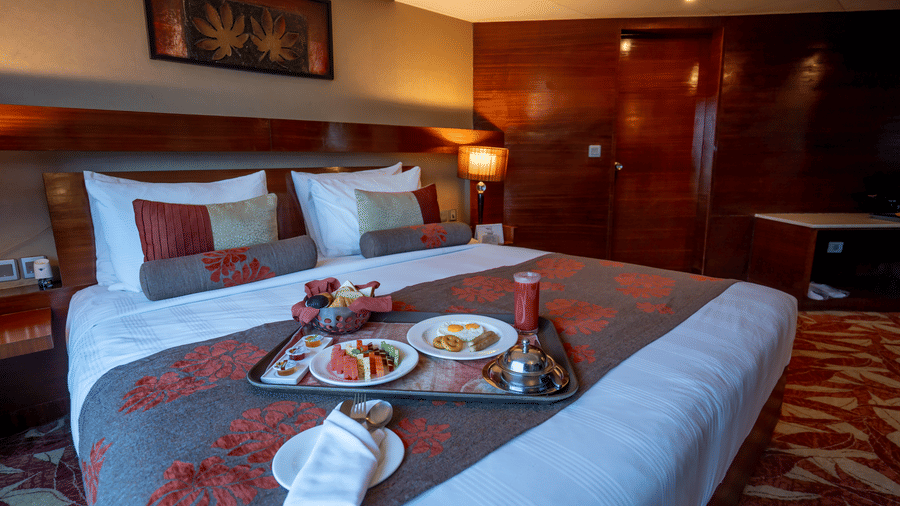 Spacious living area with sofa seating and large window offering natural light at The Pride Premier Nagpur.