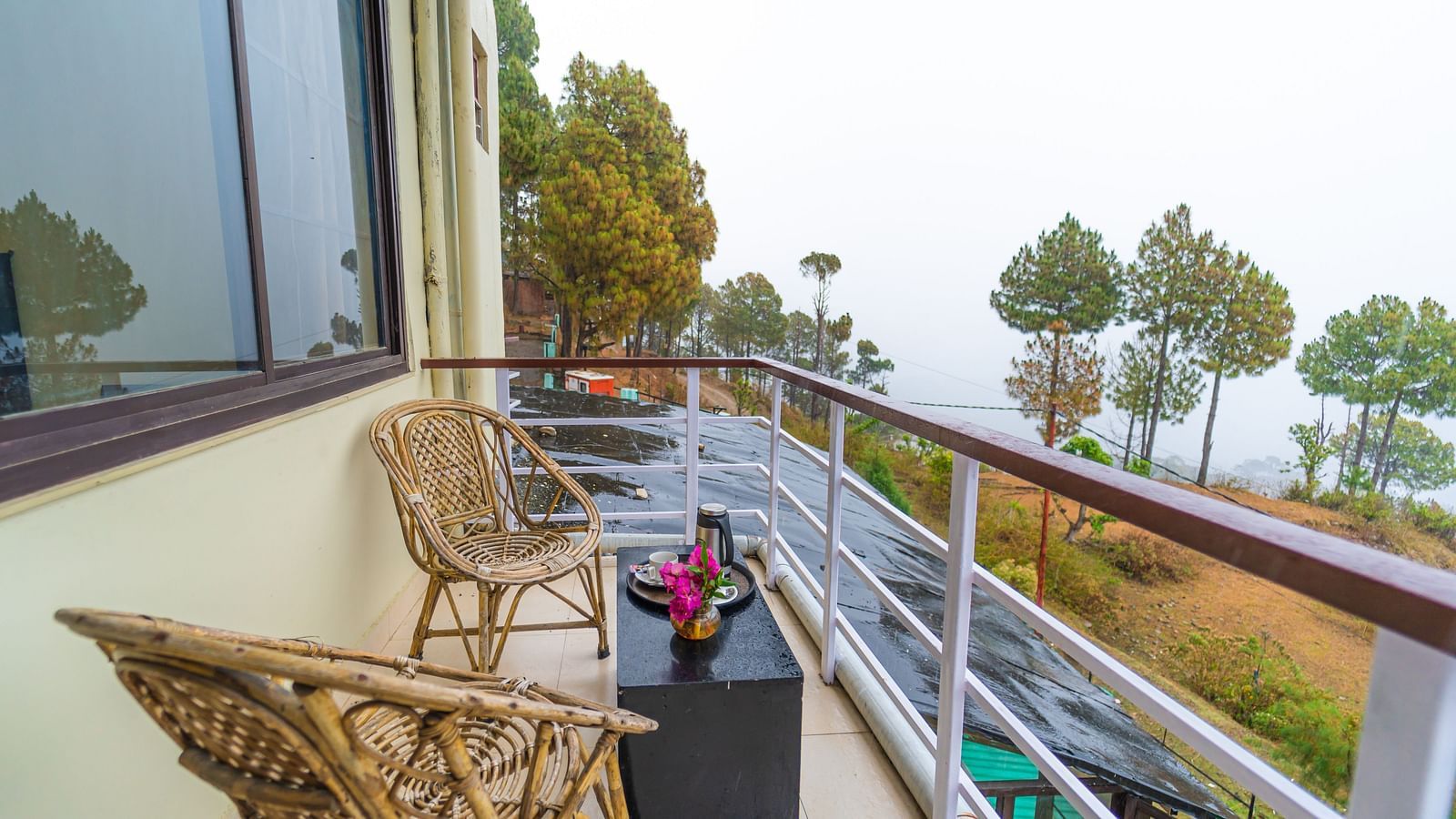 a balcony at Flutter Hotels & Resorts featuring chairs and table