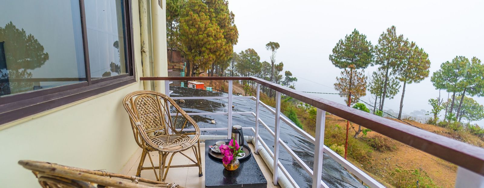 a balcony at Flutter Hotels & Resorts featuring chairs and table