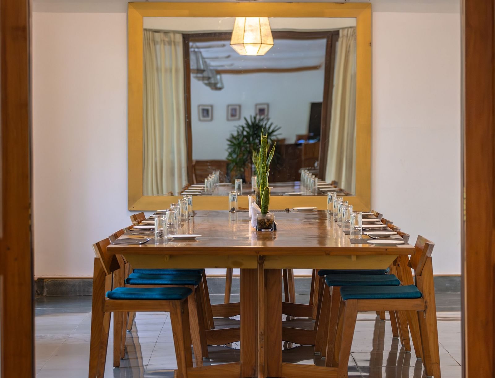 The Boardroom at Saraca Resort & Spa Corbett with a large table placed in the centre of a room with a chandelier above it