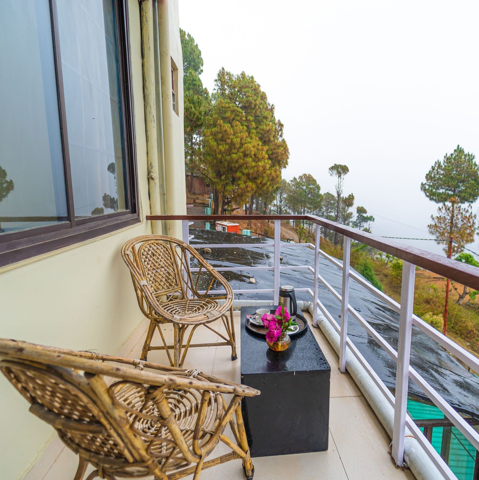 a balcony at Flutter Hotels & Resorts featuring chairs and table