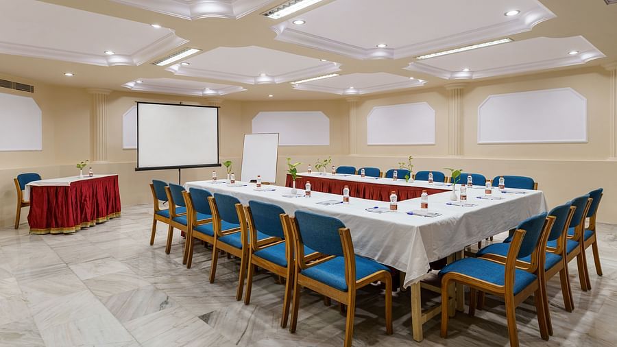 interior of a conference hall with a big table and chairs around it - Hotel Rajdarshan, Udaipur.