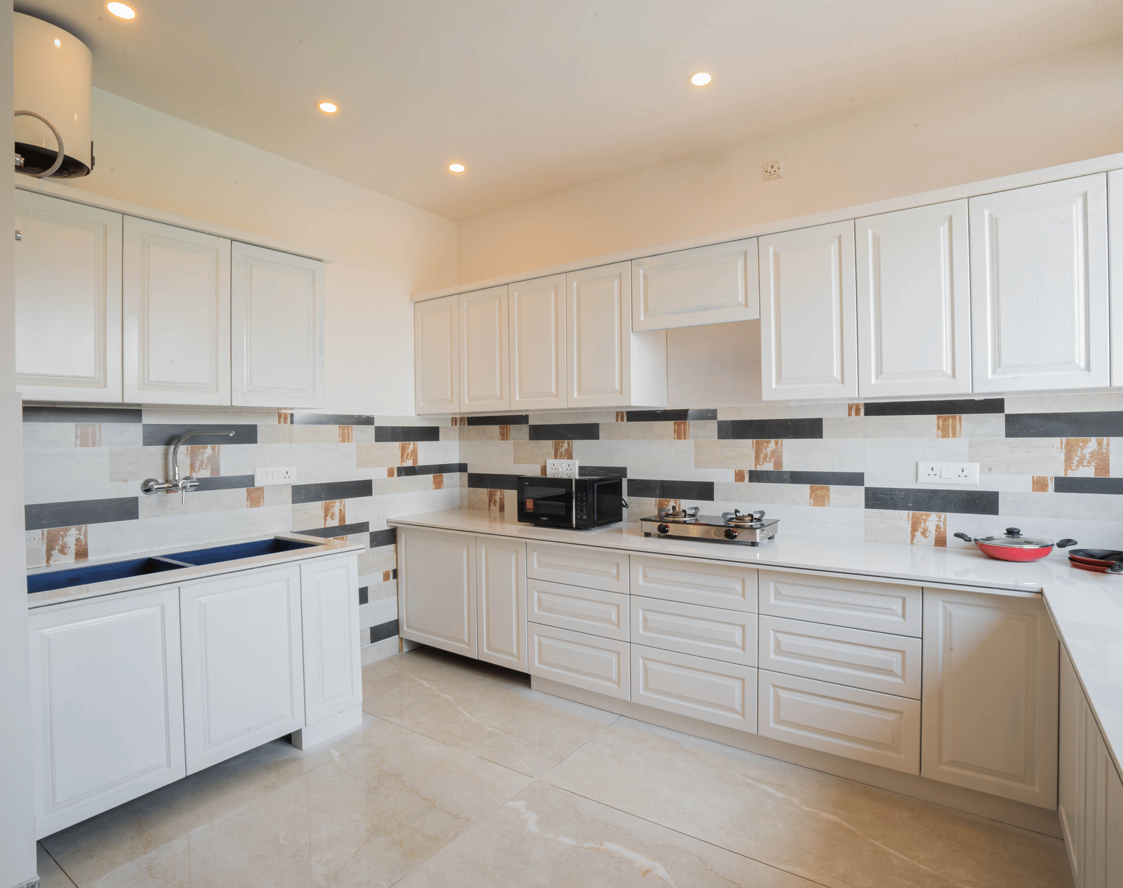 A kitchen with cabinets, tiled walls, and cooking appliances at Perfectstayz Value Paradise, Mussoorie.