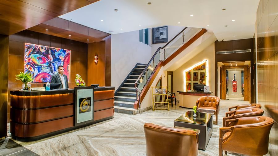 The reception area and lobby with a staircase at The Citi Residenci Hotel, Asansol.