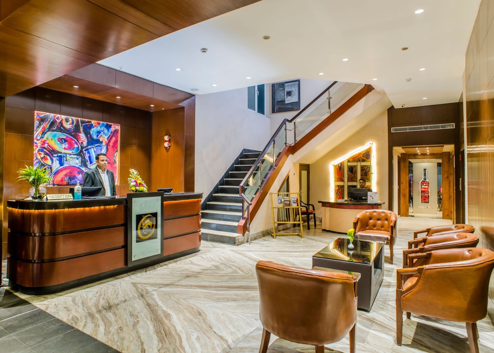 The reception area and lobby with a staircase at The Citi Residenci Hotel, Asansol.