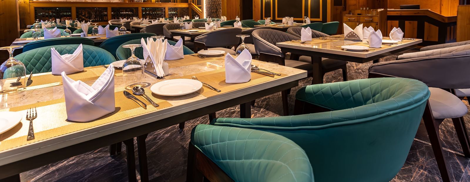 An image of a well-lit restaurant with seating arrangement and tables laid out with cutlery - The Belvedere Himalayan Retreat, McLeodganj