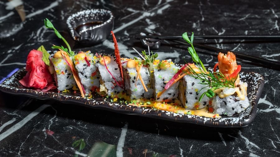 Colourful sushi platter with garnish on a black marble table at Best Western Premier Westlands hotel's Asiatic rooftop bar and restaurant.