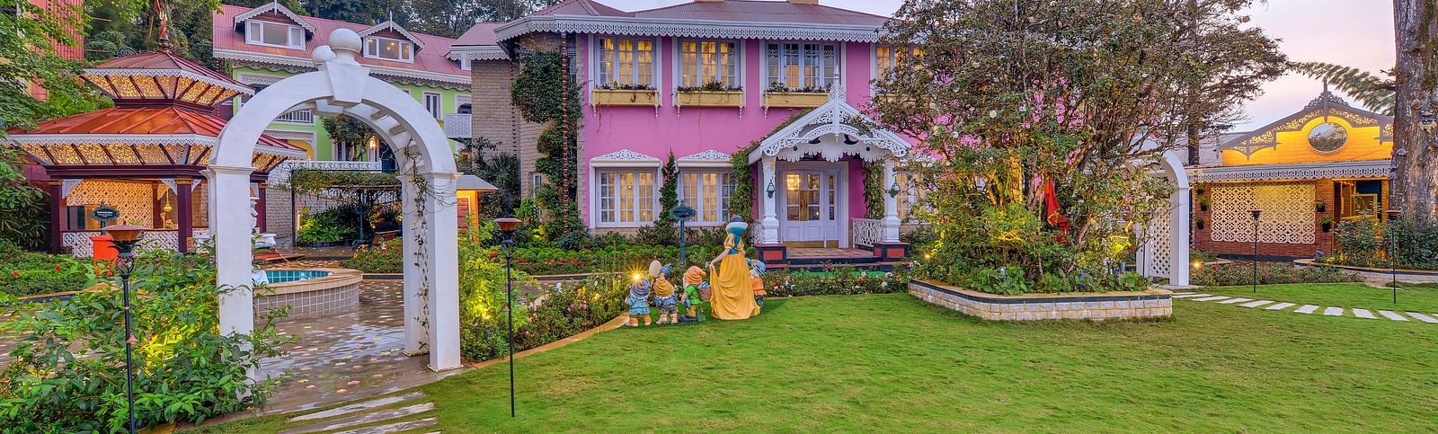 the resort with the lawn in front of it - Mayfair Himalayan Spa Resort Kalimpong