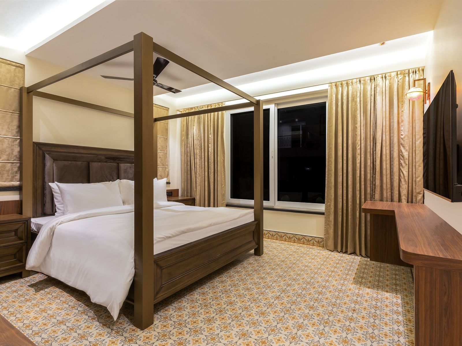 A double bed with wooden beams inside one of the rooms - The Tanisi Hotels & Resorts, Goa