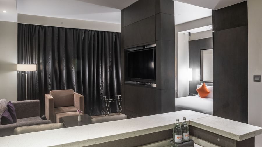 Guest suite with sofa, bed, and TV at Best Western Premier Westlands.