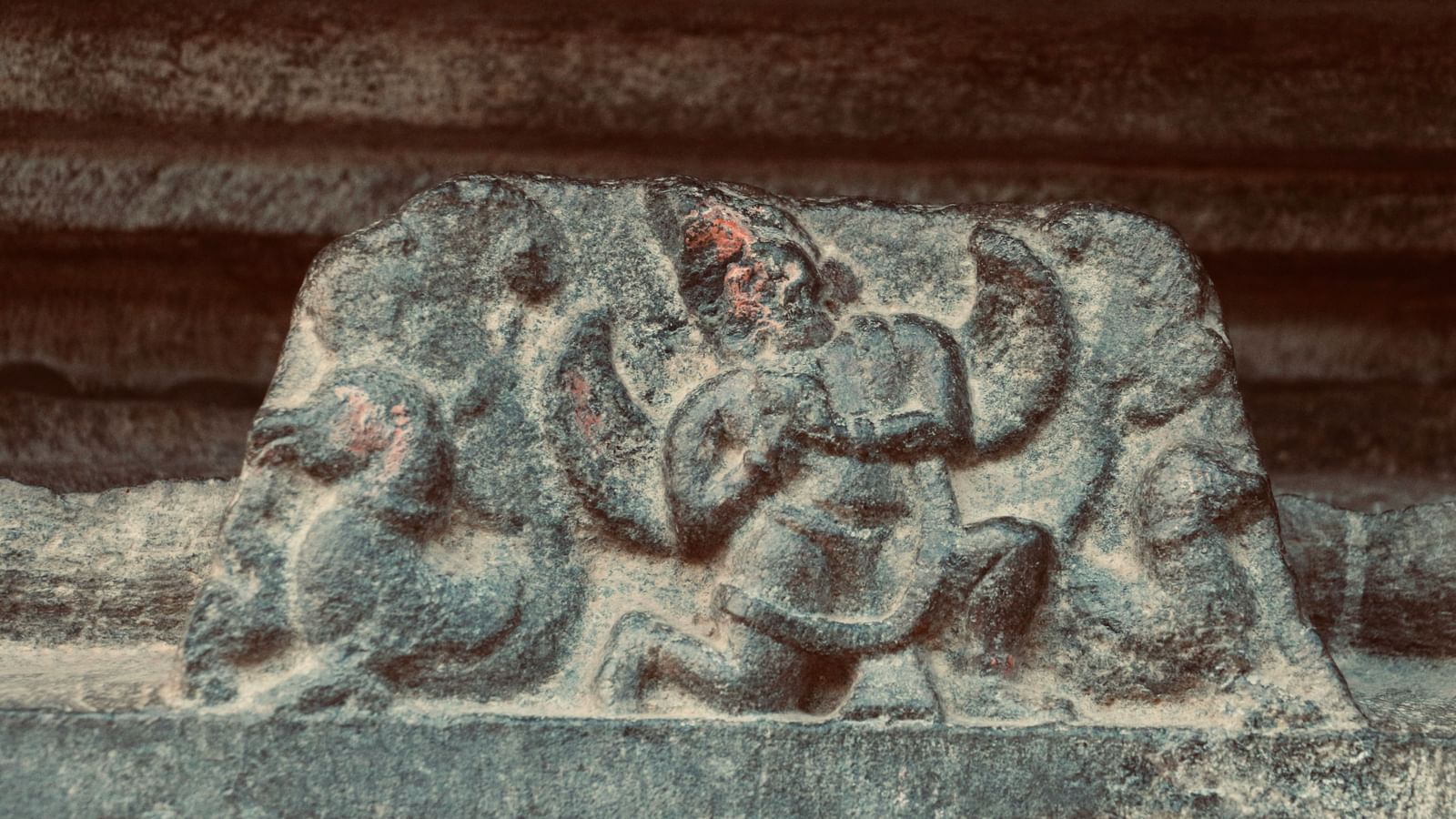 A close up of a intricate rock carvings on the outer wall at a temple in Hassan.
