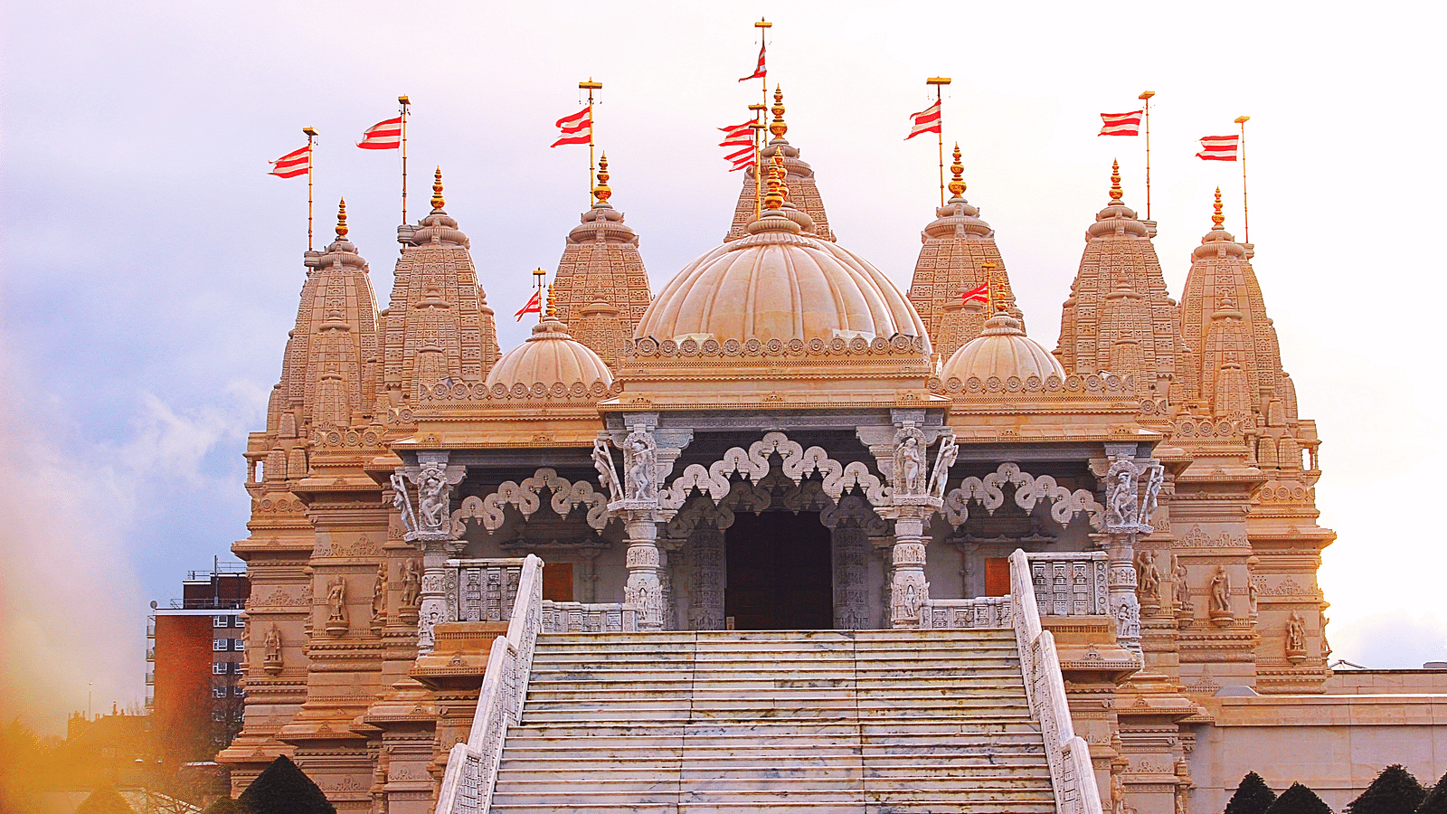 Facade of a temple during day time with blue sky in the background